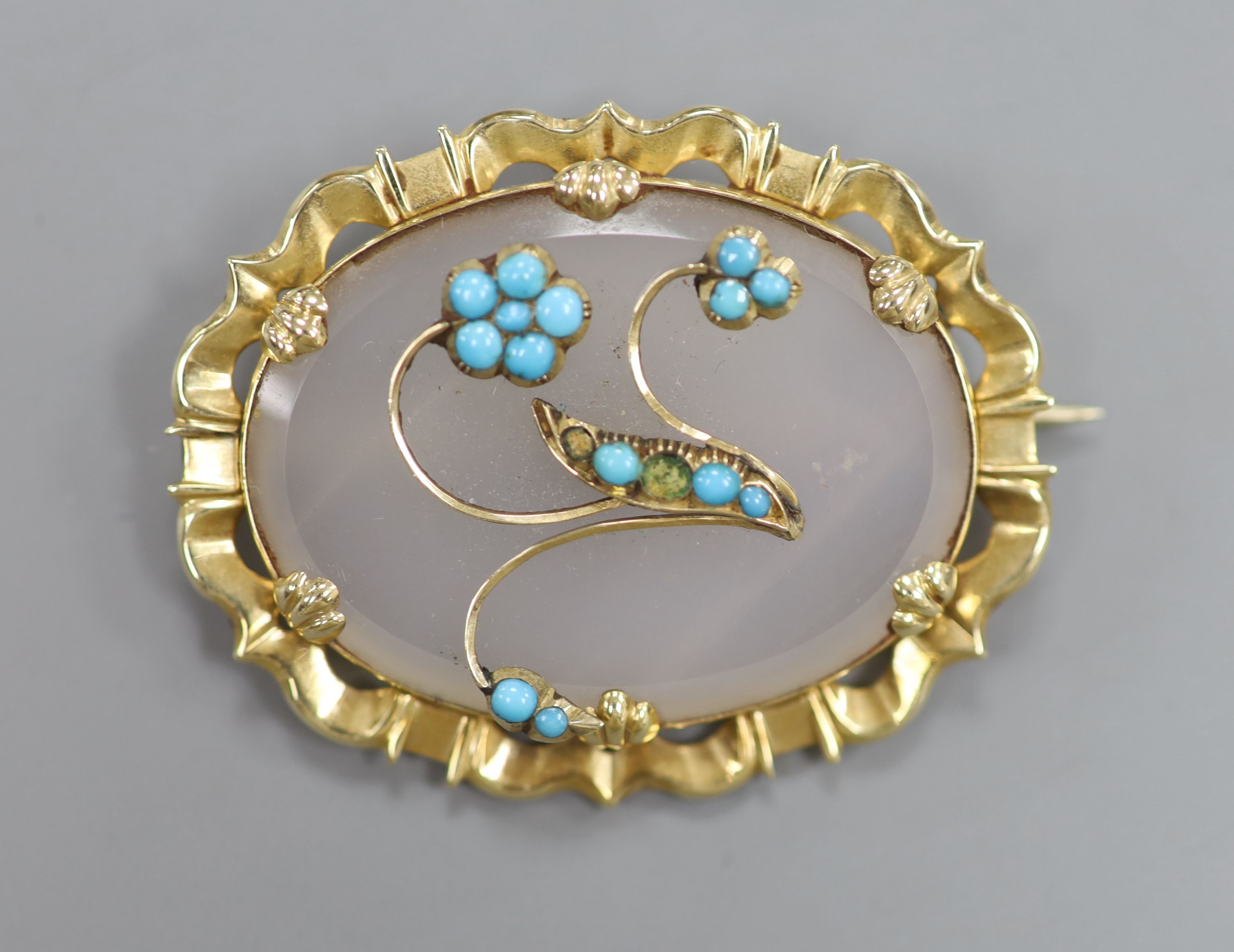 An early 20th century yellow metal mounted, white chalcedony and turquoise set oval brooch, 44mm, gross 15.1 grams